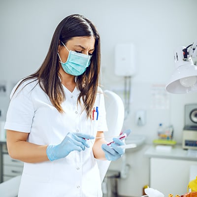 A dental assistant prepping for a patient in a dental office