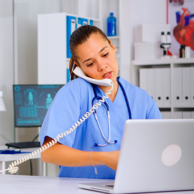 A medical professional scheduling a patient over the phone