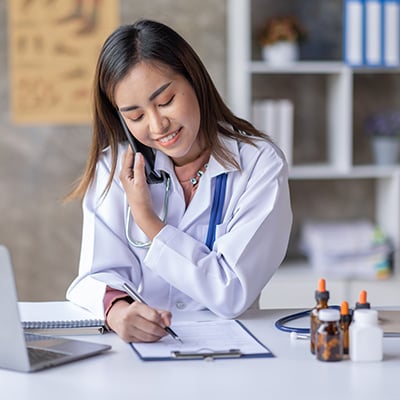 A medical professional speaking to a patient over the phone